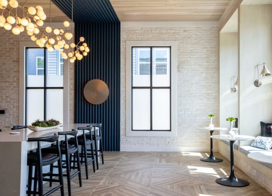 a dining room with black chairs and a long table and a large window