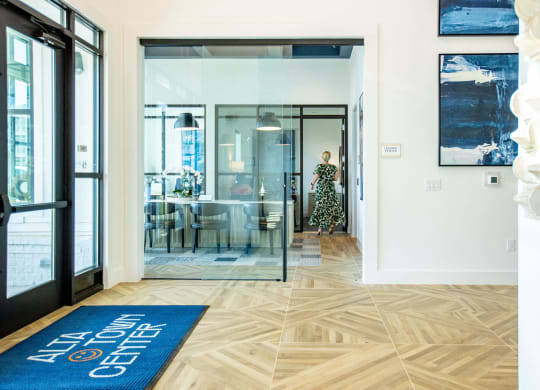 a living room with a blue rug and a glass door
