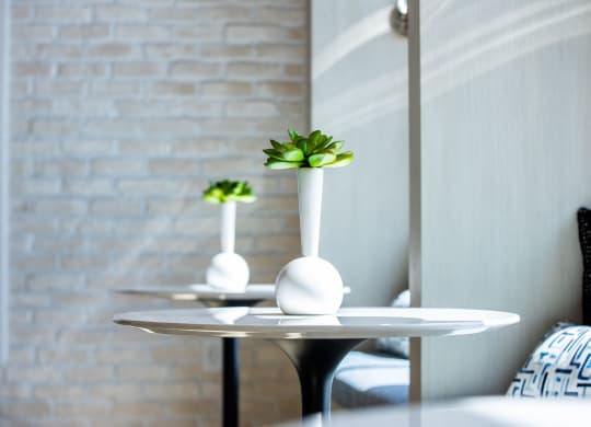 a small table with a vase on top of it