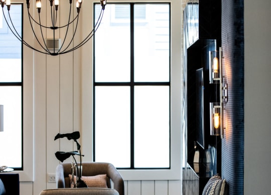 a living room with a couch and chairs and a large window