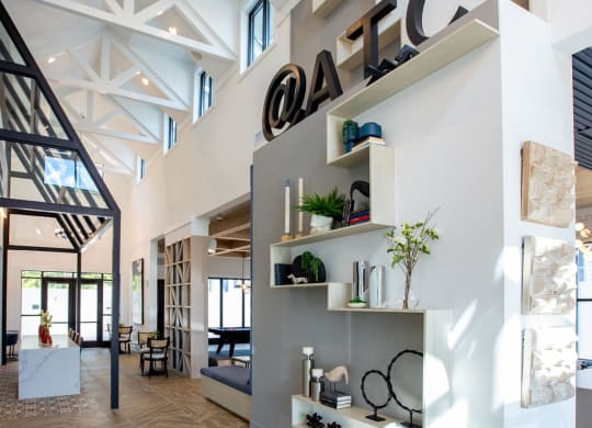 a view of the lobby of a modern house with white walls and wood floors