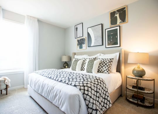 a bedroom with a bed and pictures on the wall