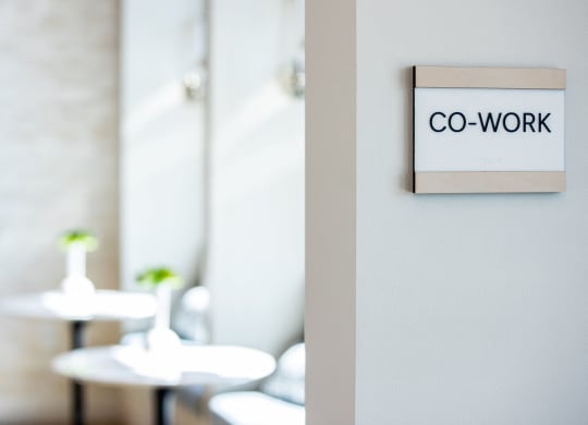 a co work sign on a wall in a restaurant