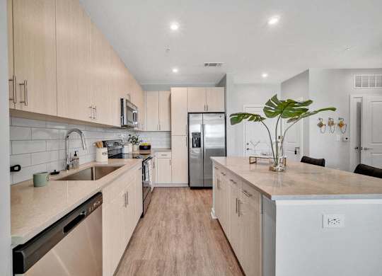 a kitchen with white cabinets and a stainless steel refrigerator