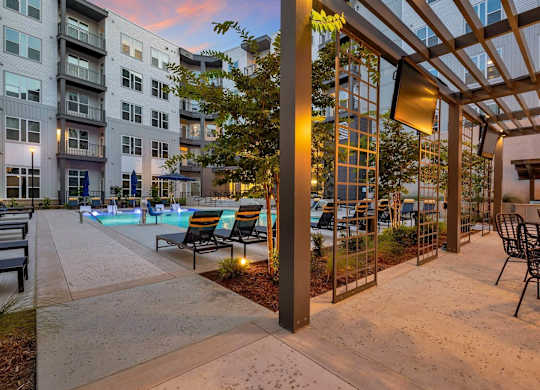 apartments with a pool and patio at dusk