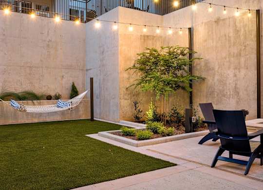 a courtyard with a hammock hanging on the wall