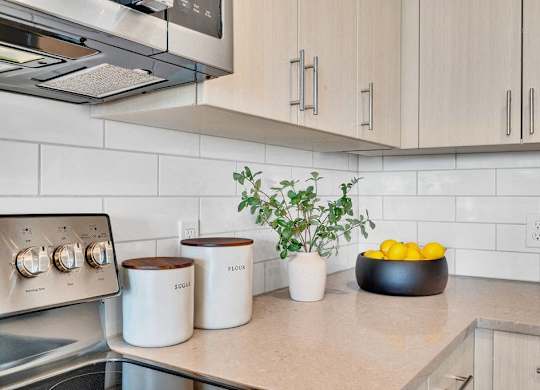 a kitchen counter with a bowl of fruit on it