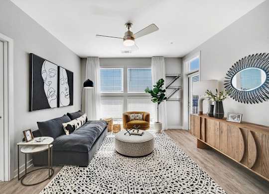a living room with a couch and a ceiling fan