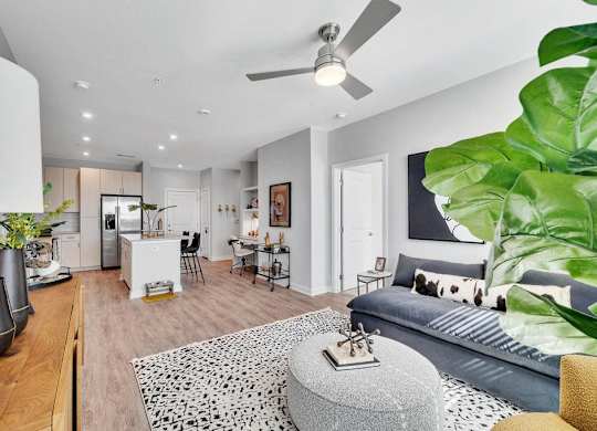 a living room with a couch and a ceiling fan