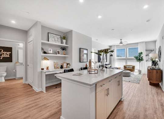 the kitchen is open to the living room and dining room