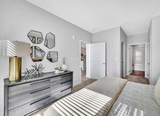 a bedroom with a bed and a dresser in it