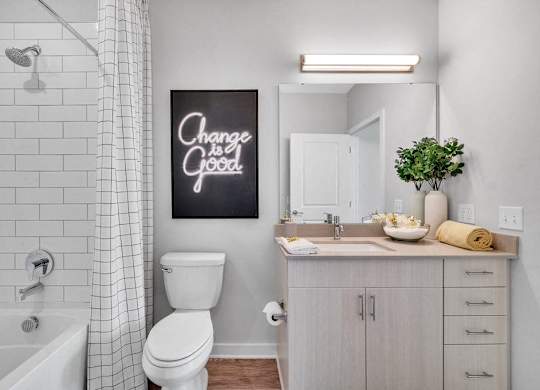 a bathroom with a sink toilet and a bath tub