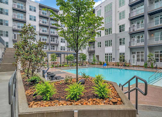 a swimming pool in front of an apartment building