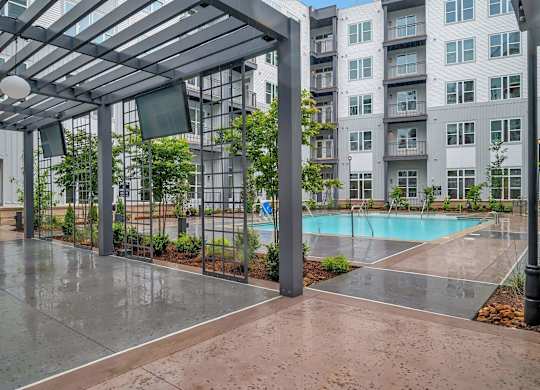 an empty pool in front of an apartment building