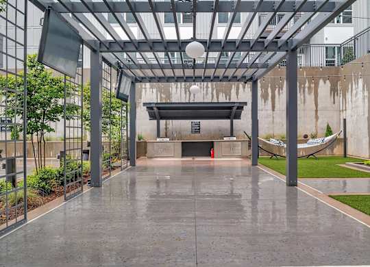 the lobby of a building with a pool and a hammock