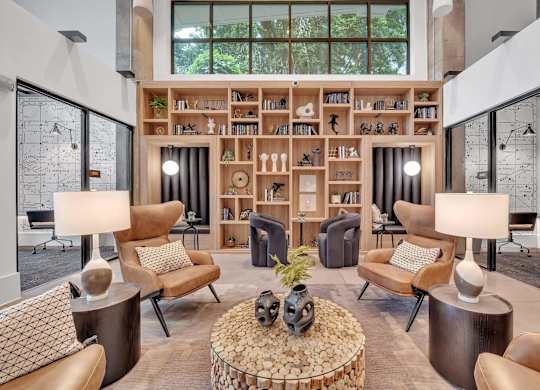 a living room filled with furniture and a book shelf