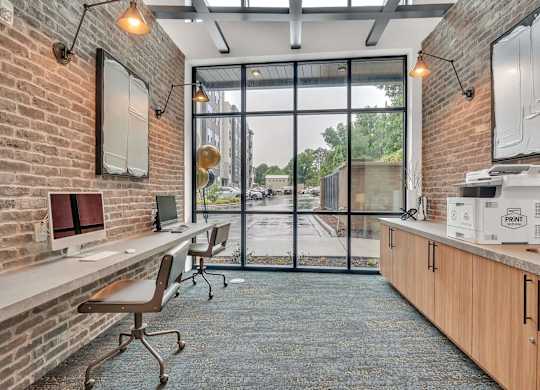 an office with a brick wall and a large window