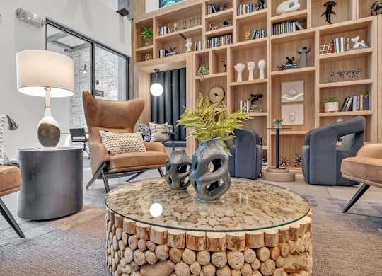 a living room filled with furniture and a large book shelf