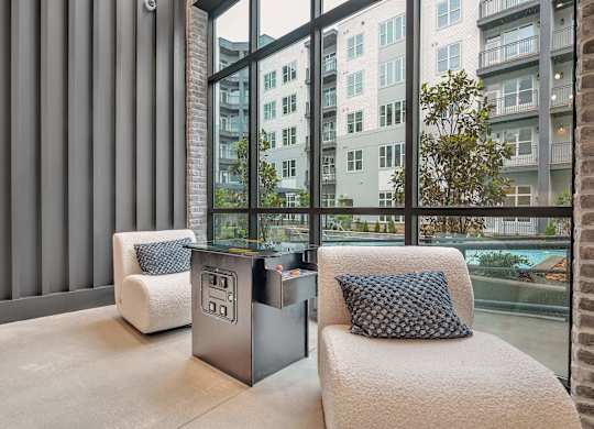 a living room with a couch and a table in front of a window