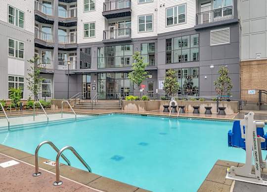 a swimming pool in front of an apartment building