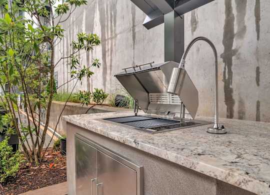 a kitchen counter with a sink and a faucet
