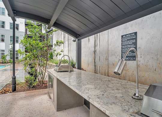 the kitchen has a concrete countertop and a sink with a large counter
