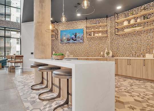 a restaurant with a white counter and stools in a lobby