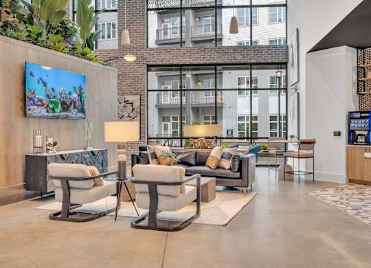 a living room with couches and chairs and a tv