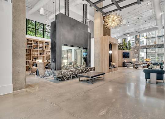 the lobby of a building with a large fireplace