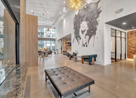 a lobby with a bench and a table