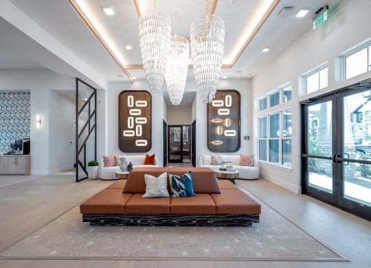 a living room with a couch and chandeliers