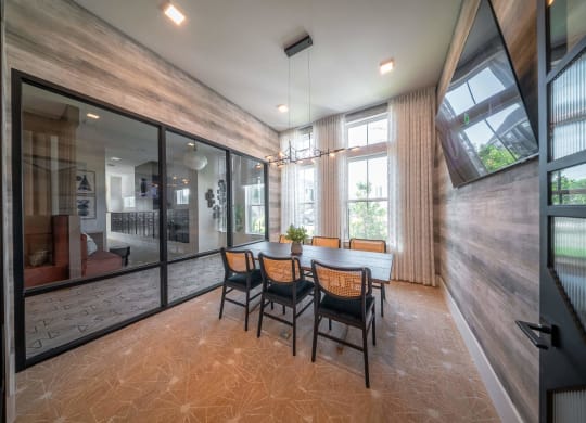 a dining room with a table and chairs and a large window
