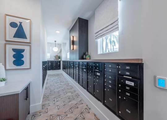 a long room with a long row of drawers and a wall with a window