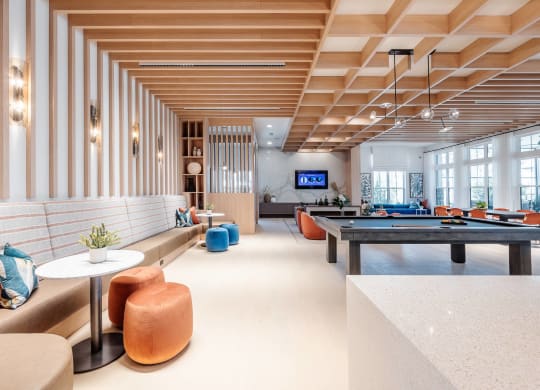 the lobby of a hotel with a pool table