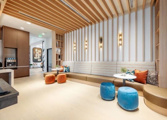the lobby of a hotel with seating and tables