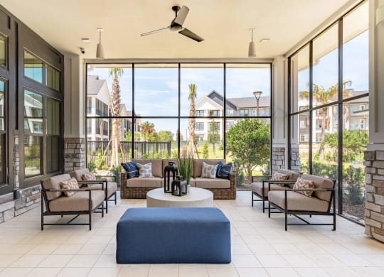 a living room with furniture and large windows