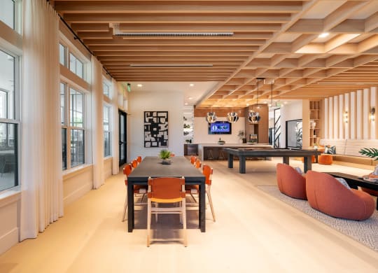 a dining room with a long table and chairs