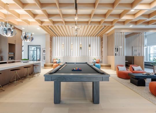 a living room with a pool table in the center of it