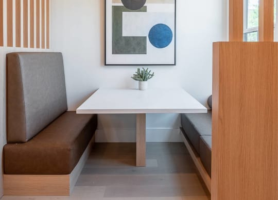 a small dining room with a white table and a chair