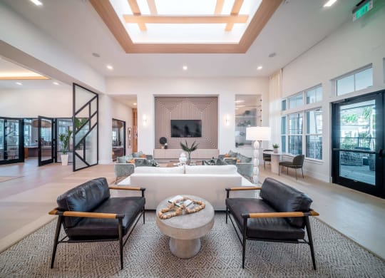 a large living room with a large white couch and chairs
