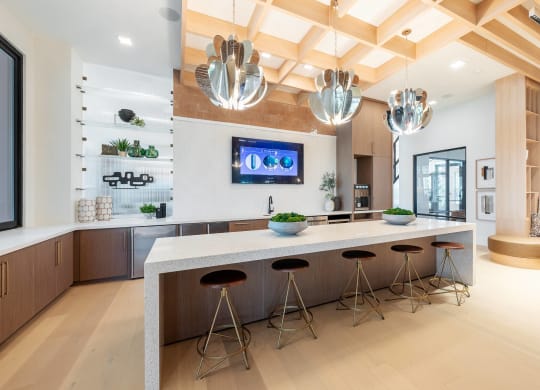a kitchen with a large island with bar stools
