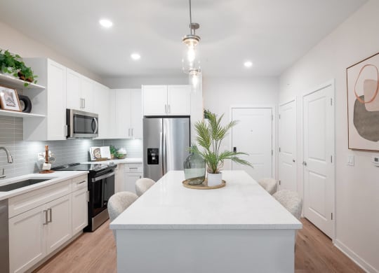 a kitchen with white cabinets and a white counter top
