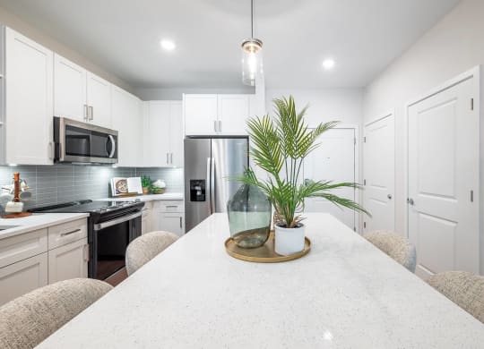 a kitchen with white cabinets and a white counter top