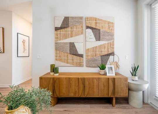 a living room with a table and a painting on the wall
