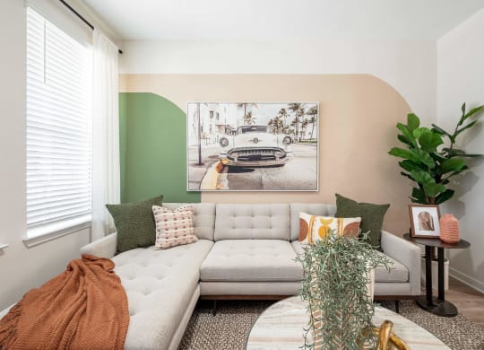 a living room with a couch and a painting on the wall