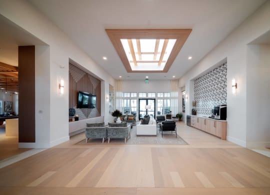a large living room with furniture and a ceiling light