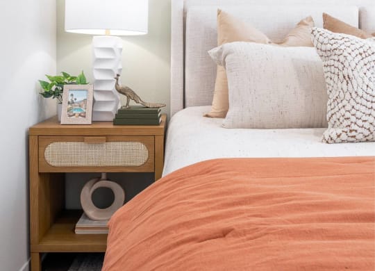 a bedroom with a bed and two pictures of palm trees on the wall