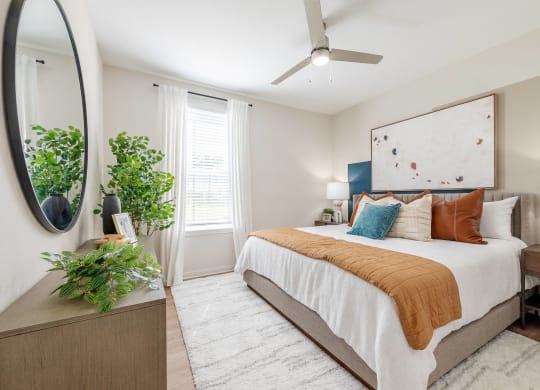 a bedroom with a large bed and a mirror