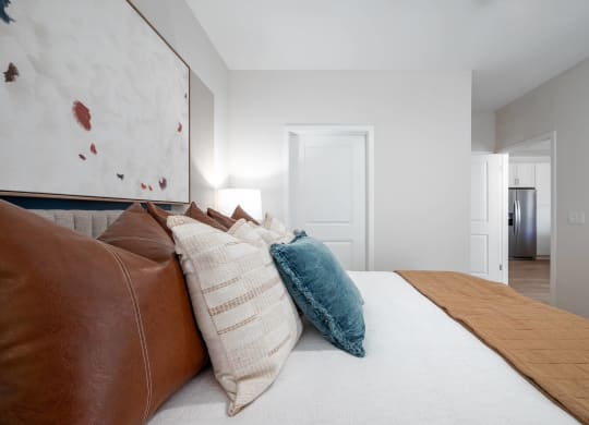 a bedroom with a large bed with pillows