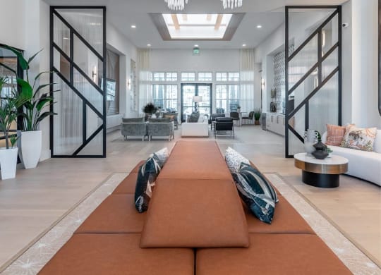 the living room has chandeliers and a large rug